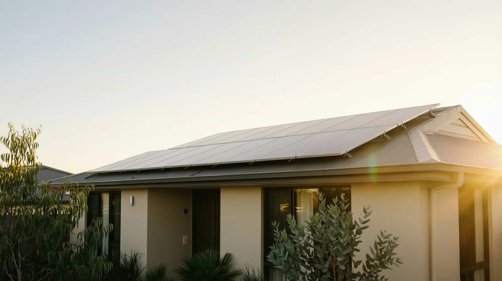 A modern Australian home with rooftop solar at golden hour